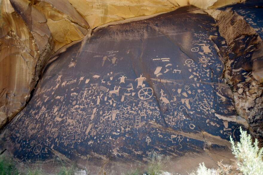 FILE - Newspaper Rock, featuring a rock panel of petroglyphs in the Indian Creek Area, is seen near Monticello, Utah, on July 14, 2016. (AP Photo/Rick Bowmer, File)