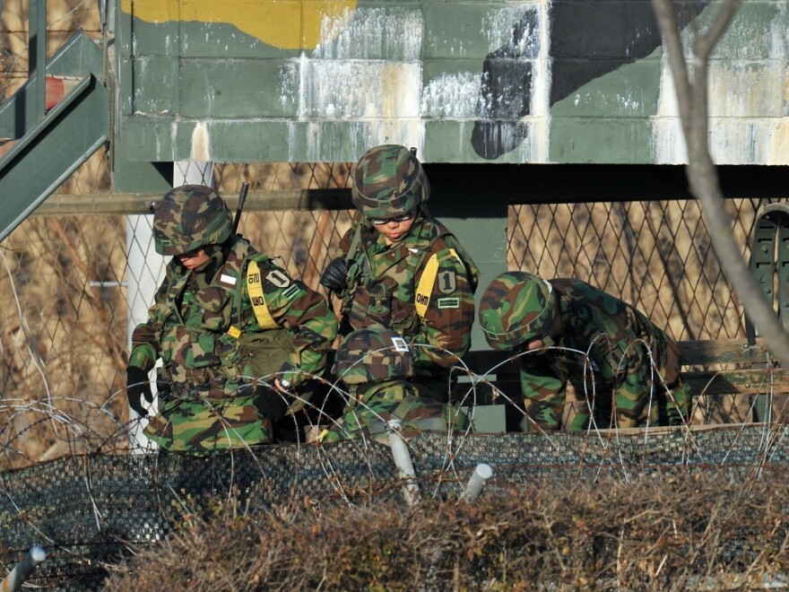 South Korean soldiers get out of a truck at a military guard area in Paju near the Demilitarized Zone separating North and South Korea on Thursday. South Korea said it will strengthen its military forces on five islands bordering North Korea following a deadly artillery attack by Pyongyang.