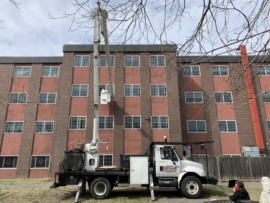 Nick Avtges in a bucket truck outside his wife Marion's window. (Courtesy) 