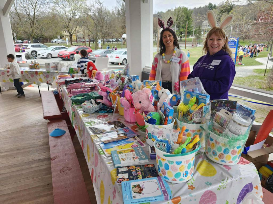 Volunteers display the Easter basket prizes.