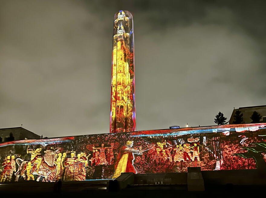 Liberty Memorial lit colorfully with classic-looking characters