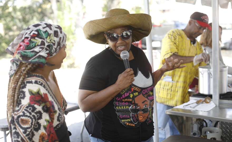 Festival attendees share the microphone with Gabrielle E. W. Carter during the 2022 Publix Tampa Bay Collard Festival in St. Petersburg, Florida, on Saturday, February 19, 2022. Photo by Octavio Jones for WUSF