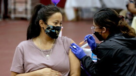 A woman receives a Pfizer vaccination booster shot from a nurse in Los Angeles. California Department of Public Health officials say that no fully vaccinated adult should be denied a COVID-19 booster shot in the state.