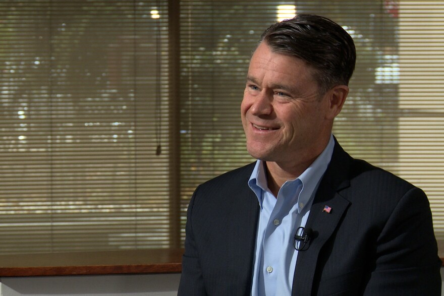 Todd Young smiles during an interview. He is a White man with dark hair with grey streaks in it. 