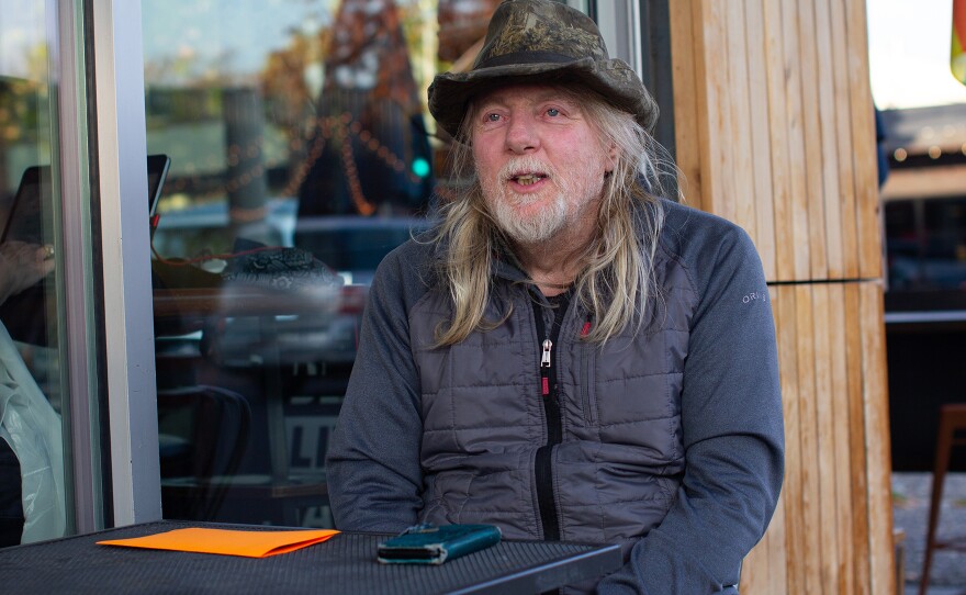 Cass Davis, a SNAP recipient, sits outside of One World Cafe in Moscow on Thursday, Oct. 30, 2025.