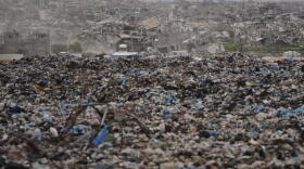 Destruction left by the Israeli air and ground offensives stand behind a landfill in Khan Younis, Gaza, Thursday, Jan. 22, 2026. (Jehad Alshrafi/AP)