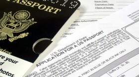 A sample passport atop an application for a US passport.