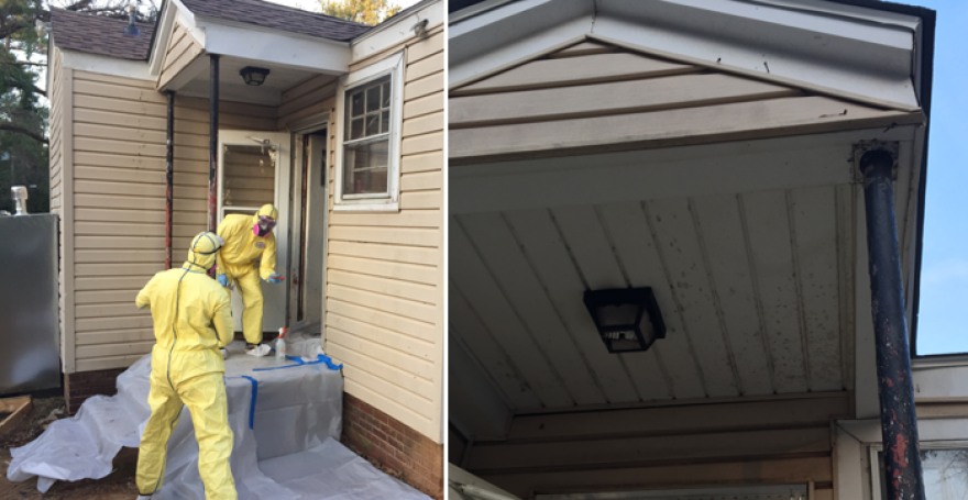 Volunteers wear protective suits while making repairs to home.