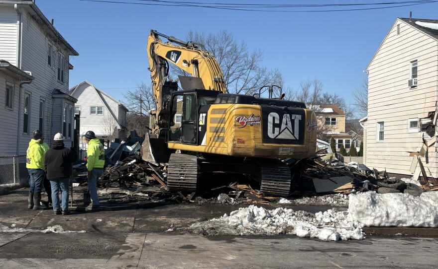 Crews demolish a fire-damaged house at 66-68 N. Welles St., Kingston, on Friday, Feb. 13, 2026 following a fatal fire two days earlier.