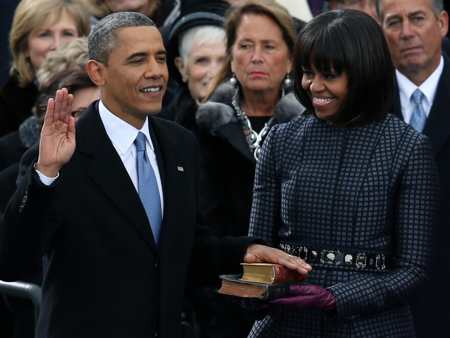 President Obama taking the oath of office today on the steps of the Capitol. First Lady Michelle Obama held the two Bibles on which he placed his hand.