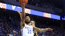 Kentucky's Davion Mintz (10) shoots while defended by Vanderbilt's Scotty Pippen Jr. during the first half of an NCAA college basketball game in Lexington, Ky., Wednesday, Feb. 2, 2022. (AP Photo/James Crisp)