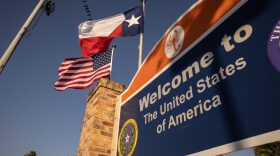 The U.S. and Texas flags fly near the U.S.-Mexico border in Brownsville, Texas.