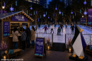 Rendering of people ice skating at an outside rink with lights all around 