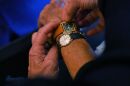A customer tries watches at a watchmaker shop on Oct. 26, in Nantes, western France, two days before the end of Daylight Saving Time.
