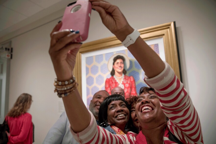 Relatives of Henrietta Lacks were on hand when her portrait went on display at the Smithsonian's National Portrait Gallery in Washington, D.C. Granddaughters Jeri Lacks-Whye (right) and Kimberly Lacks (center) pose with other direct descendants for a selfie in front of the portrait.