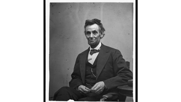  Abraham Lincoln, three-quarter length portrait, seated and holding his spectacles and a pencil