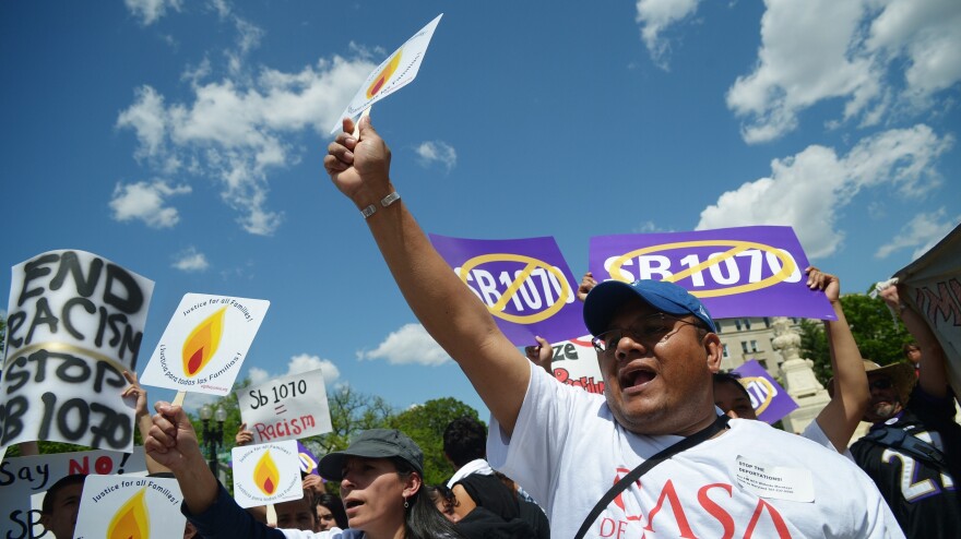 Protesters outside the U.S. Supreme Court shout slogans during an April 25 protest against Arizona Senate Bill 1070.