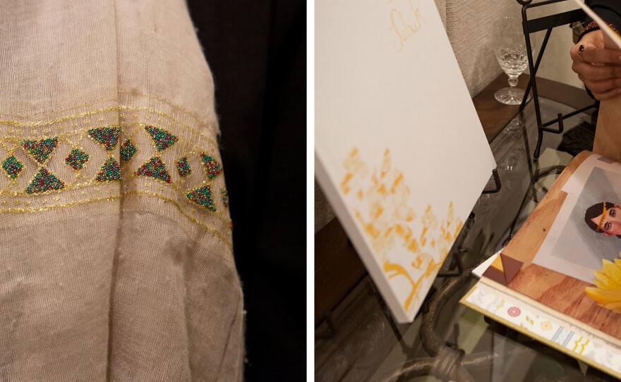The artists, all students or recent graduates of the all-female Dar Al-Hekma University, wore pins (left) with the school logo. Rawabi al-Sanusi turns pages in a book she designed on old family stories (right).