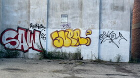 Graffiti pictured on a building near the corner of Wayne Avenue and Jones Street. The city of Dayton has been encouraging people to report graffiti so it can be removed.