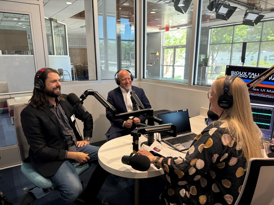Andrew Reinartz (right) and Randy Cohen (left) visit with Lori Walsh.