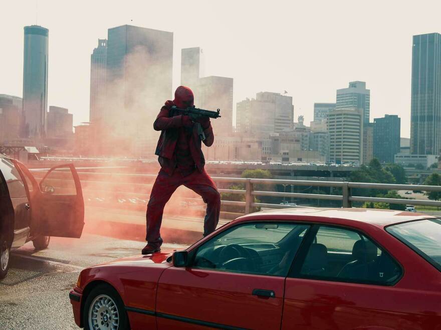 Armed thieves make their getaway on the Atlanta freeway in <em>Triple 9</em>.