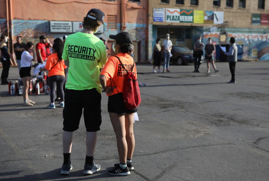 Security Latinos De La Lake volunteers wear bright T-shirts prominently displaying the group's name, in part, to let law enforcement know who they are.