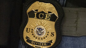 FILE - A federal agent wears an Immigration and Customs Enforcement badge in New York, June 10, 2025. 