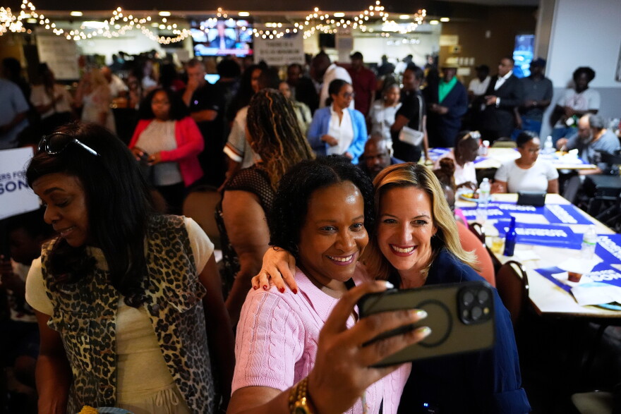Michigan Secretary of State Jocelyn Benson, right center, the Democratic gubernatorial nominee, poses for a photo with Rose Dady, at a campaign event at the Trade Union Leadership Council in Detroit, Tuesday, Aug. 18, 2026. (AP Photo/Paul Sancya)