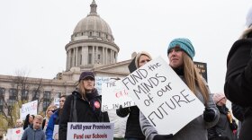 Teachers, students and supporters march in front of the capitol on April 2 during a walkout aimed at increasing education funding.