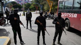 Pro-government armed civilians block streets in Caracas, Venezuela, Saturday, Jan. 3, 2026, after U.S. President Donald Trump announced that President Nicolás Maduro had been captured and flown out of the country. (AP Photo/Matias Delacroix)
