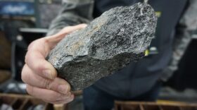 A chunk of rock containing graphite picked up from the surface of the Graphite Creek site.