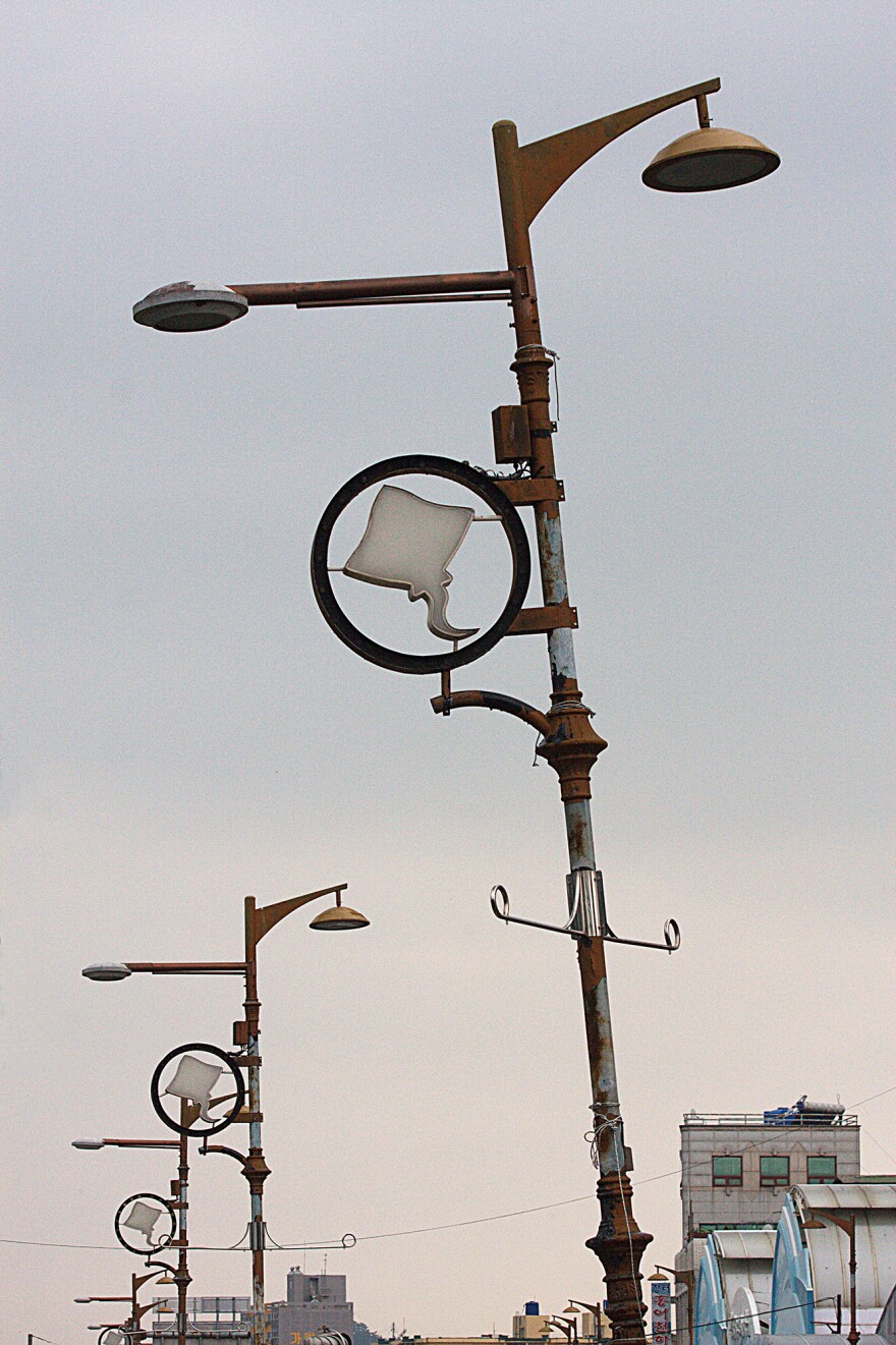 Trawling for skate, the key ingredient in <em>hongeo</em>, is big business in Mokpo's bustling harbor, as the decorations on these lampposts attest.