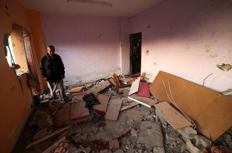 Men check a home destroyed by Israeli bombardment in a Rafah refugee camp in the south Gaza Strip, on Jan. 1, amid the ongoing conflict between Israel and Hamas.