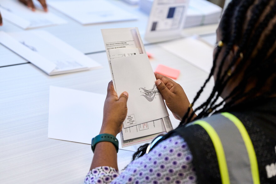 Wake County Board of Elections employees prepare absentee ballots to be mailed on Thursday, Sept. 3, 2026, in Raleigh, N.C.