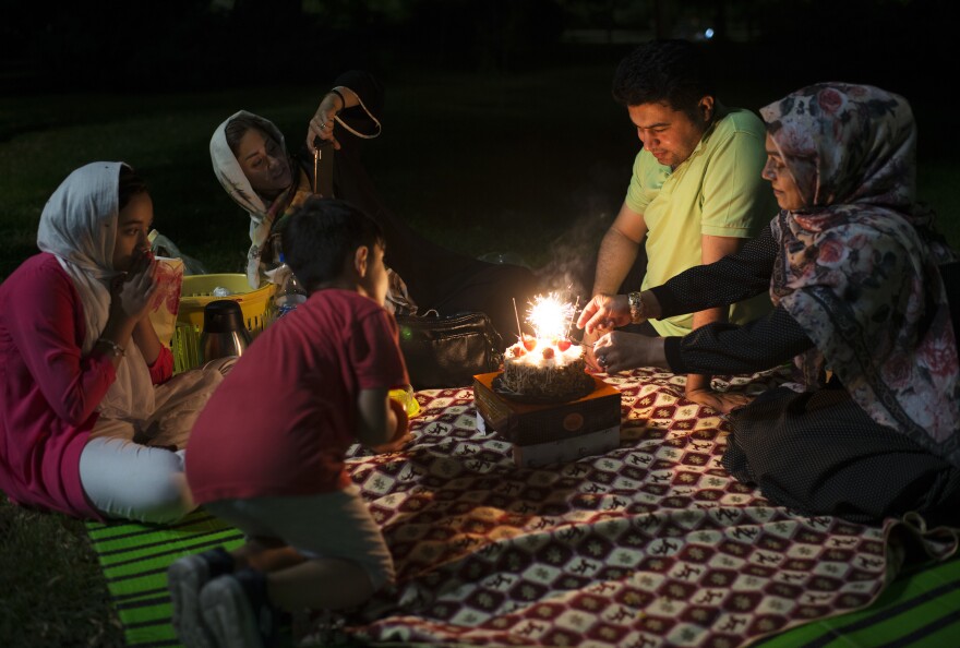 A family gathers in a Tehran park the night before a public holiday in August.
