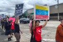 People march through Orlando’s Mills 50 neighborhood on Saturday in protest of the United States’ military intervention in Venezuela.