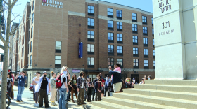 A group organized by IU Divestment Coalition members gather outside the Monroe County Courthouse Tuesday afternoon to protest charges against two members.