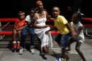 Dierdre Wortham relaxes while members of her family play around her. Her son, Aiden (second from left) had to forgo treatment after the state removed them from Missouri's Medicaid program. 