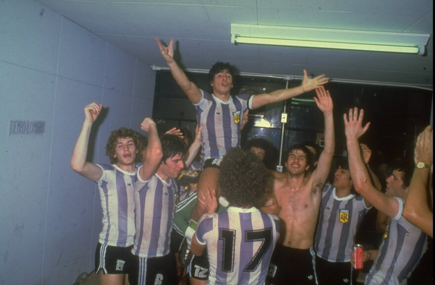 Maradona, center, celebrates with his teammates after winning a game.