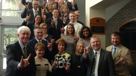 USF officials, led by Provost Ralph Wilcox, first row left, and System President Judy Genshaft, first row third from left, celebrate Thursday in Orlando after a FL Board of Governors committee approved USF as a preeminent university.