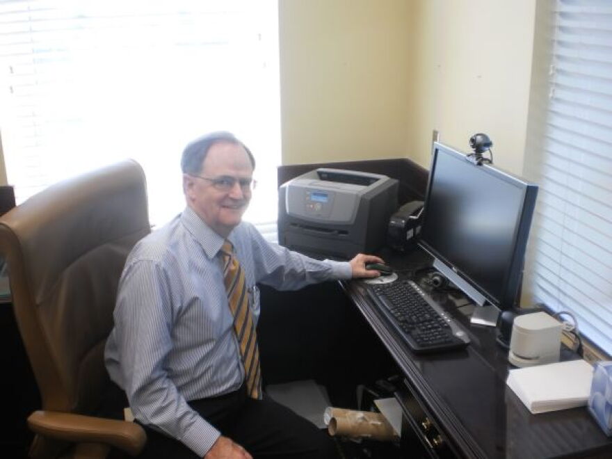 Lee Todd at his desk after turning off his computer for the last time as president
