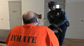 A corrections officer talks with an inmate at the Joseph Harp Correctional Center in Lexington.