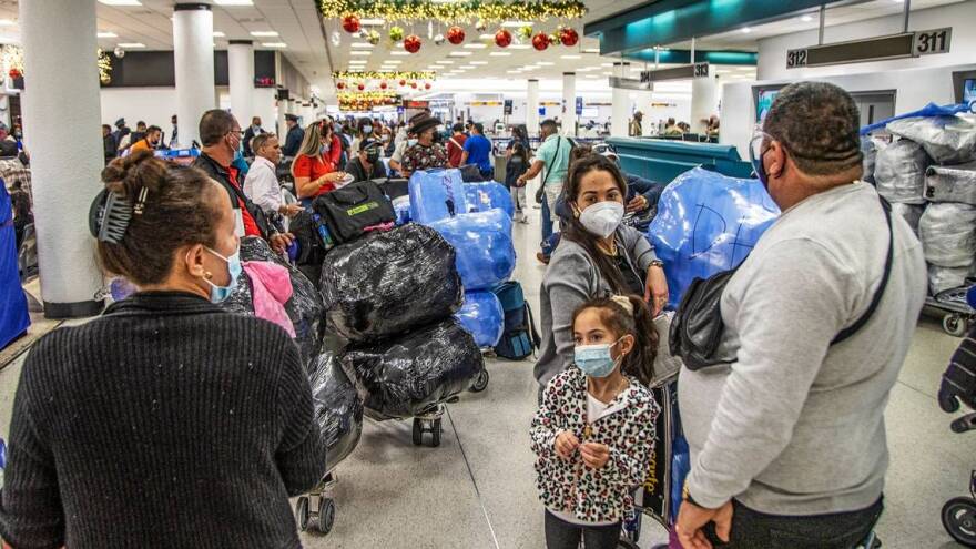 Travelers heading to Cuba are seen at Miami International Airport on Wednesday, December 23, 2021. Cuba is dropping COVID restrictions for international travelers despite new surges around the world. Tourism to the Caribbean island took a big hit during the pandemic.