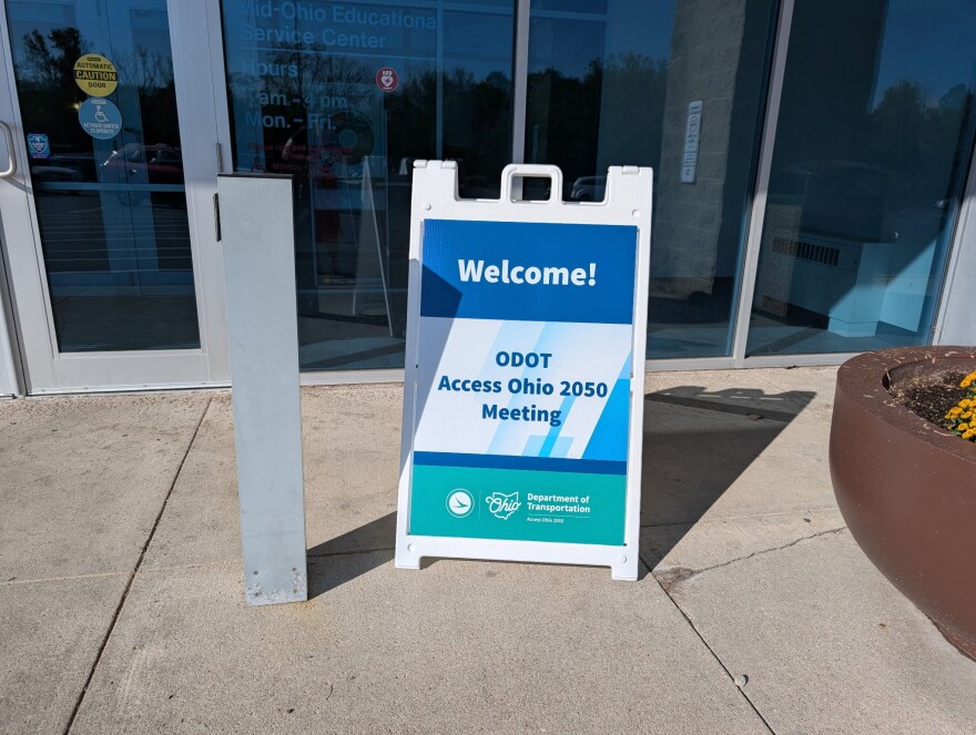 A sign says, "Welcome! ODOT Access Ohio 2050 Meeting," with the Ohio Department of Transportation and state logos underneath. 