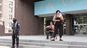 Asia Rose Gibbs speaks to a crowd of over 50 at the steps of the Dayton Federal Building