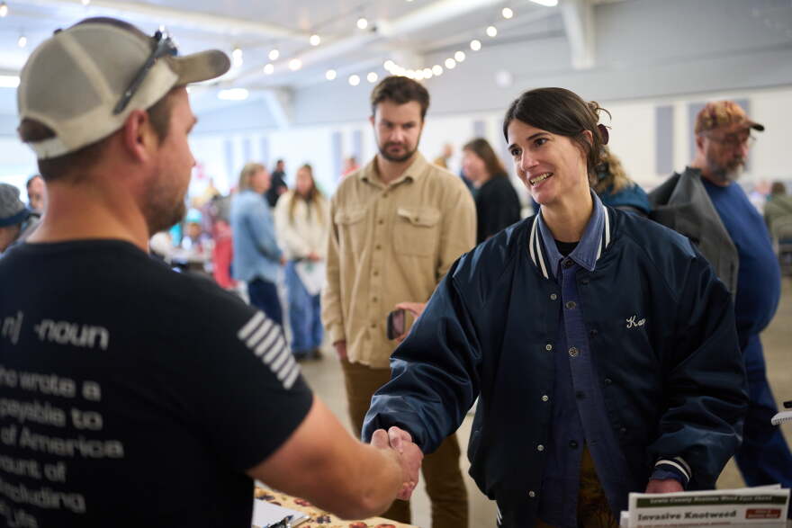 Rep. Marie Gluesenkamp Perez, D-Wash., shakes hands with Chris Volmert, left, at the Repair and Sustainability Fair at the Southwest Washington Fairgrounds Saturday, Oct. 10, 2026, in Centralia, Wash. (AP Photo/Lindsey Wasson)