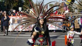 A woman wearing Native American clothing attends a "No Honor in Racism Rally" march in front of TCF Bank Stadium before an NFL football game between the Minnesota Vikings and the Kansas City Chiefs, Oct. 18, 2015, in Minneapolis. The group objects to the Kansas City Chiefs name, and other teams' use of Native Americans as mascots. As the Kansas City Chiefs return to Super Bowl on Sunday, Feb. 12, 2023, for the first time in two years, the movement to change their name and logo will be there again.