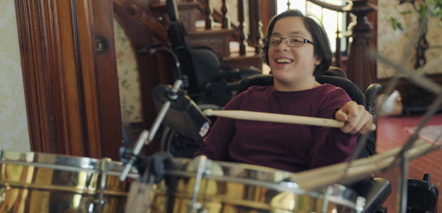 A woman drumming on a drumset