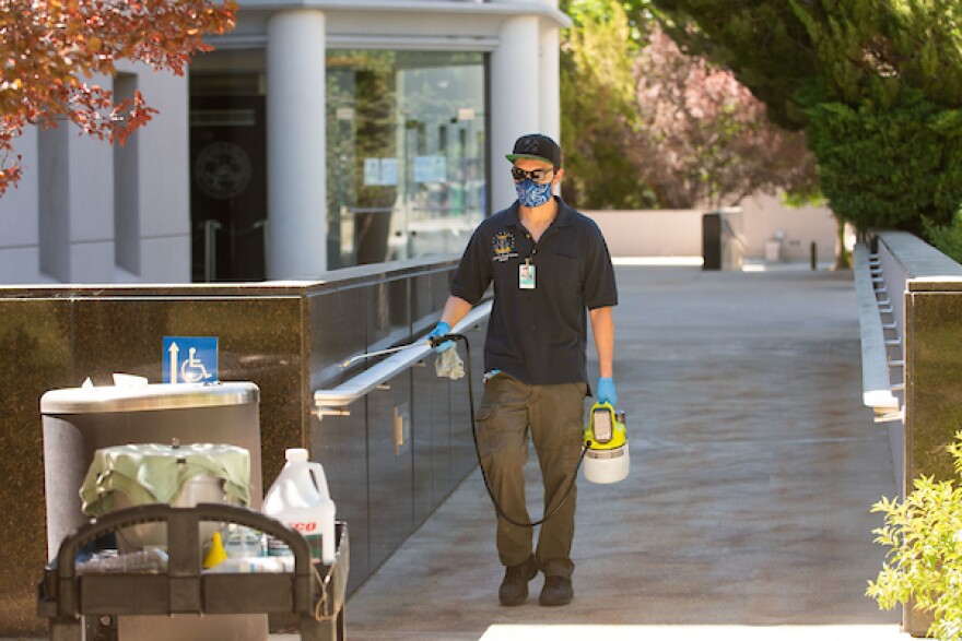 A man cleaning a railing.
