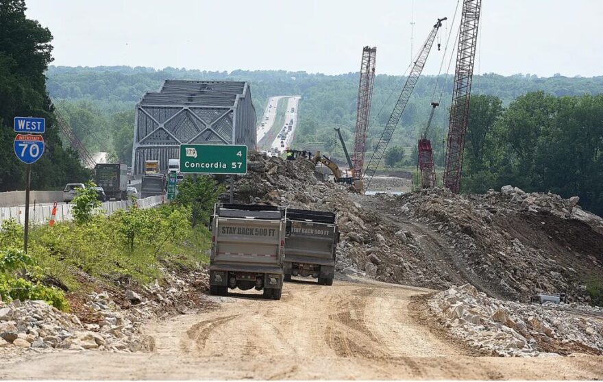  Construction workers haul limestone quarried from the river bluff to the construction site of a new Interstate 70 Missouri River bridge connecting Boone and Cooper counties.